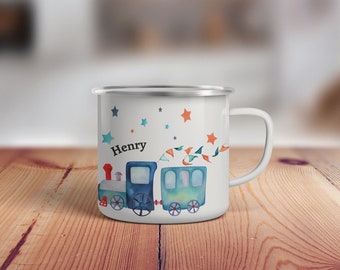 May include: White enamel mug with a blue and green watercolor train design. The train has stars and flags. The mug says "Henry" on the side.