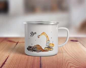 May include: White enamel mug with a yellow excavator digging up dirt and rocks. The mug has the name "Ben" written on it.