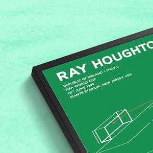 May include: A green and white framed print with the text "RAY HOUGHTON" and "REPUBLIC OF IRELAND 1 ITALY 0" in white. The text "FIFA WORLD CUP" and "18TH JUNE 1994" is also in white. The text "GIANTS STADIUM, NEW JERSEY, USA" is in white. The print features a black and white illustration of a soccer goal with a soccer ball in the net.