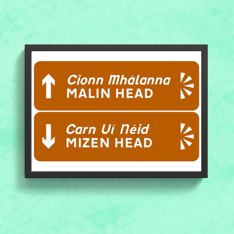 May include: A brown and white sign with two directional arrows. The top arrow points up and says "Cionn Mh&aacute;l&aacute;nna MALIN HEAD". The bottom arrow points down and says "Carn U&iacute; N&eacute;id MIZEN HEAD".