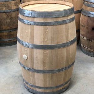 May include: A wooden barrel with metal hoops. The barrel is made of light brown wood and has a natural finish. The metal hoops are silver in color and are evenly spaced around the barrel.