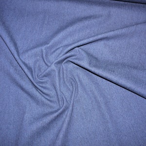Könnte beinhalten: Nahaufnahme eines blauen Jeansstoffes mit einer strukturierten Oberfläche.