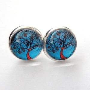 May include: A pair of silver stud earrings with a blue and red tree of life design.