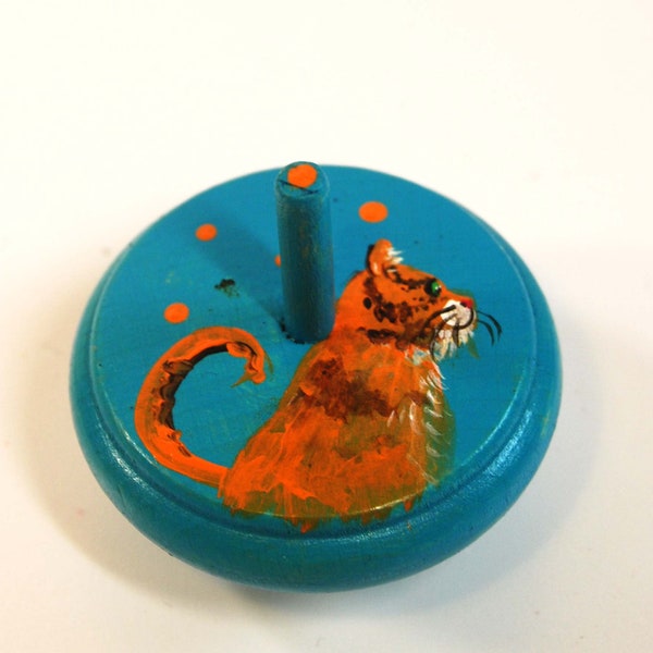 Wooden gyroscope, toy painted with a cat