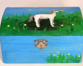 Treasure chest with a unicorn on a flower meadow