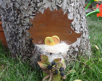 Edelrost hedgehog on a birch trunk