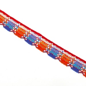 May include: Red, orange, blue, and white crocheted trim with a delicate, lacy pattern.