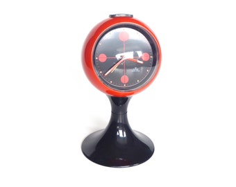 Horloge de table des années 70, réveil pied tulipe "Lève-toi !" Ancre principale rouge-noire