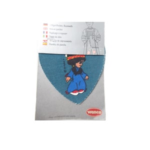 May include: A blue denim patch with a cartoon girl wearing a blue dress and red shoes. The patch is labeled "Disney" and is packaged with instructions in multiple languages.