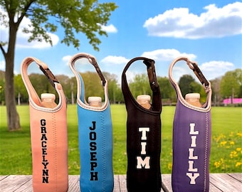 May include: Four personalized water bottle holders with different names: Gracelynn, Joseph, Tim, and Lilly. The holders are made of a soft, insulated material and have a carrying strap. The holders are in different colors: pink, blue, black, and purple.