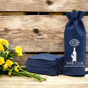 May include: A stack of navy blue wine bottle bags with a white design of a wine glass and bottle with the text "Wine Club Which is better one or two".