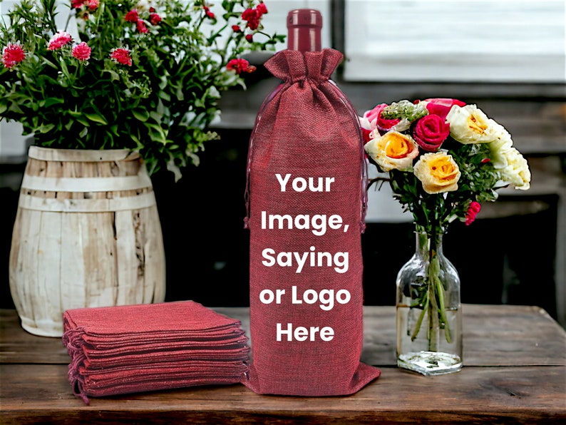 May include: A stack of red burlap wine bottle gift bags with a single bag on top with the text "Your Image, Saying or Logo Here" printed on it.