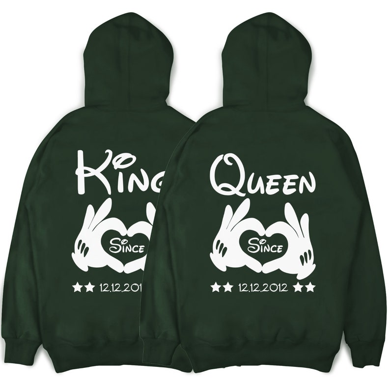 May include: Two green hooded sweatshirts with white text and graphics. One says "King" and the other says "Queen". Both have a white heart with the word "Since" and a date. The King sweatshirt says "12.12.201" and the Queen sweatshirt says "12.12.2012".
