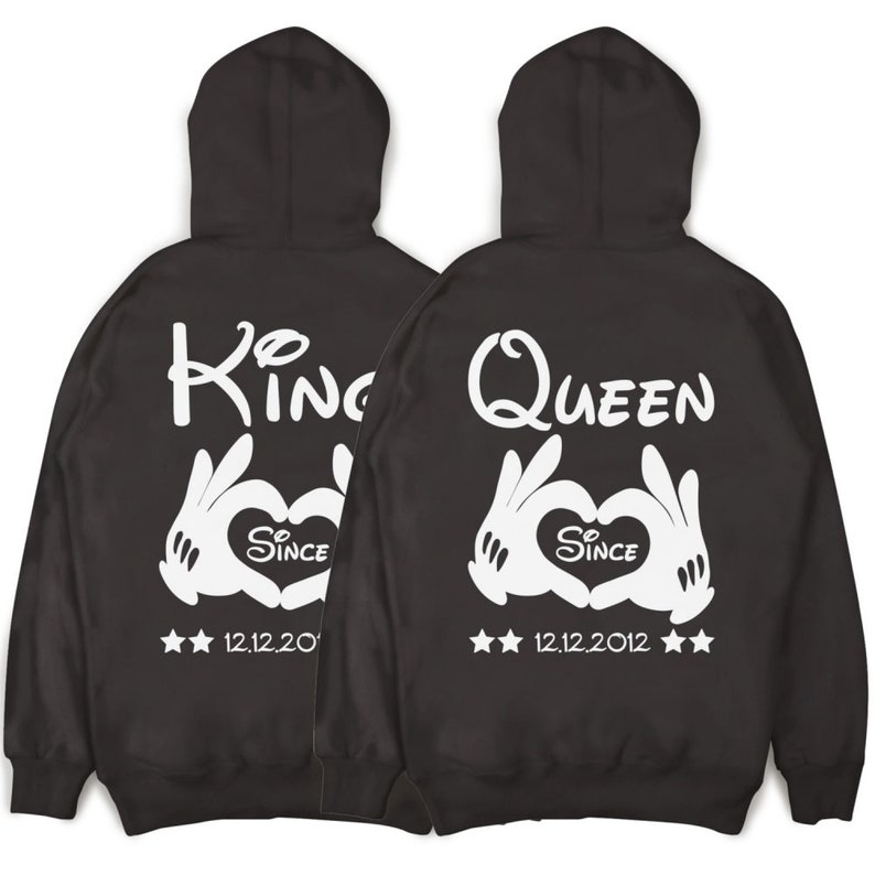 May include: Two black hooded sweatshirts with white text and graphics. One sweatshirt says "King" with a heart and the text "Since 12.12.20". The other sweatshirt says "Queen" with a heart and the text "Since 12.12.2012".
