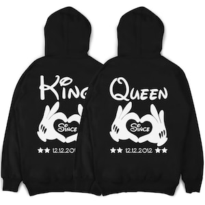 May include: Black hooded sweatshirts with white text and graphics. The left sweatshirt says "King" with a heart and "Since 12.12.2012". The right sweatshirt says "Queen" with a heart and "Since 12.12.2012".