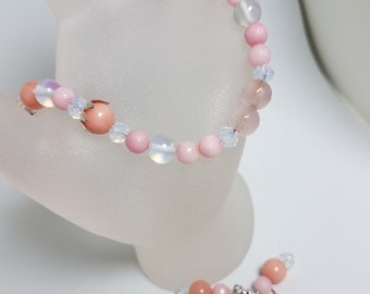 Bracelet made of morganite and moonstone beads with matching earrings. Closure is a silver tone toggle clasp