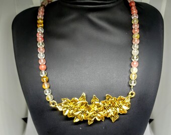 Necklace of Watermelon Tourmaline with an Ornate Gold Tone Chest Piece.  21 Inches long with a toggle clasp and matching earrings.