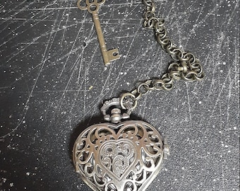 Beautiful pocketwatch in heart shape on 7 inch chain with large safety pin to hook it to lapel, shirt etc.
