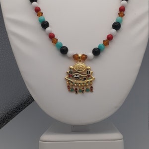 Necklace with gold plated Eye of Ra pendant beads of jade, cinnebar, gold glass and obsidian beads