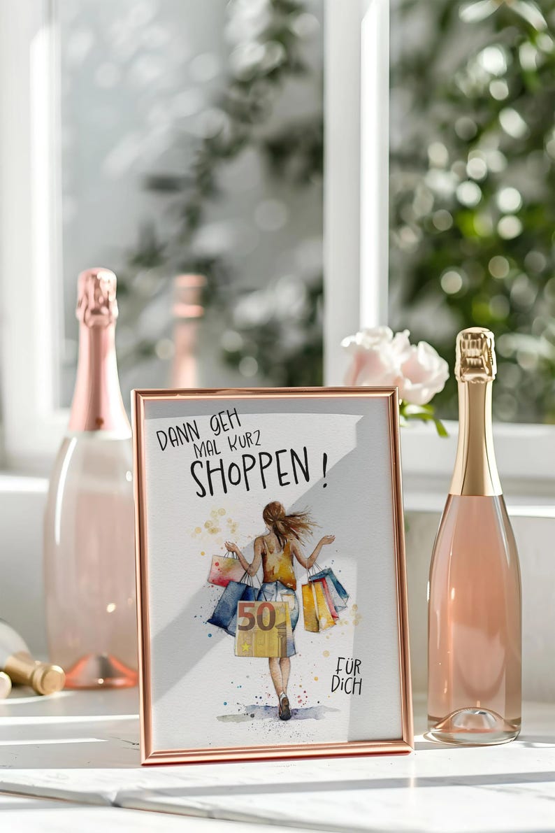 May include: A white framed picture with a rose gold border. The picture shows a woman carrying shopping bags with the text "Dann geh mal kurz shoppen!" and "F&uuml;r dich".