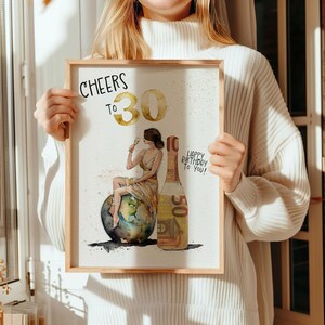May include: A watercolor illustration of a woman sitting on a globe, holding a glass of champagne. The woman is wearing a gold dress and a gold headband. A bottle of champagne is next to her, with a 50 euro bill wrapped around it. The text "Cheers to 30" is at the top of the image, and the text "Happy Birthday to You!" is at the bottom.