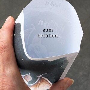 May include: A white paper cone with the text "zum bef&uuml;llen" printed on it. The cone is decorated with a watercolor illustration of a bat flying in a starry night sky.