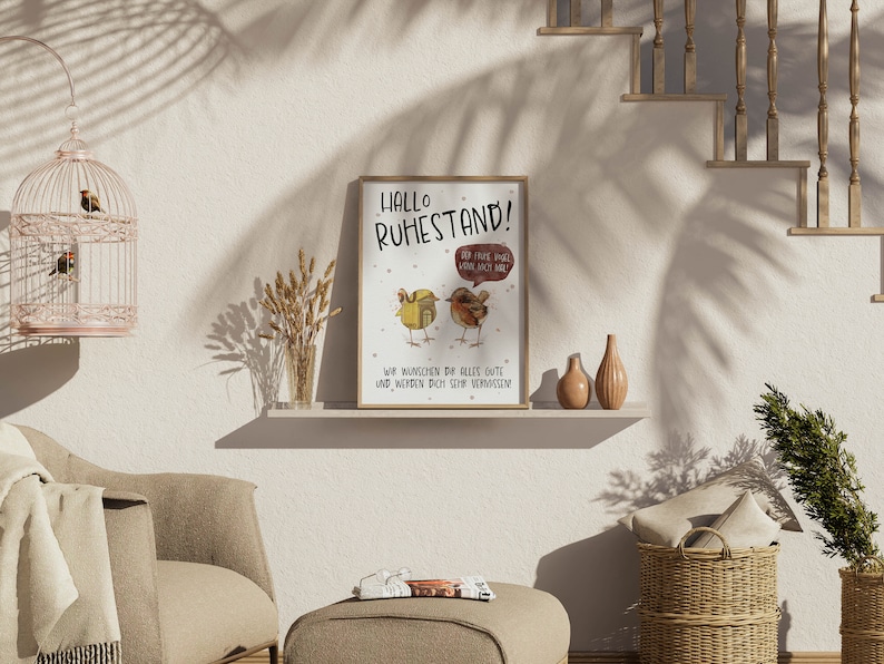 May include: A framed print with a light brown background and a cartoon illustration of two birds. The text on the print reads "Hallo Ruhestand!" and "Wir w&uuml;nschen dir alles Gute und werden dich sehr vermissen".