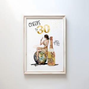 May include: A white framed print with a watercolor illustration of a woman sitting on a globe, holding a glass of champagne. The woman is wearing a gold dress and a gold crown. A bottle of champagne is next to her, with a 50 euro bill wrapped around it. The text "Cheers to 30" is written in black at the top of the print. The text "Happy Birthday to You!" is written in black at the bottom of the print.