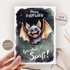 May include: A digital download card with a watercolor illustration of a bat with a toothy grin. The bat is flying against a dark blue background with stars. The text "Happy Halloween" is written in white above the bat. The text "Gruseliger Spa&szlig;!" is written in white below the bat. The text "zum bef&uuml;llen" is written in white on a pink circle in the upper right corner of the card.