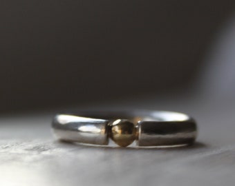 Silver ring with gold pearl