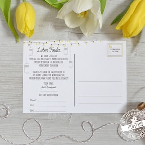 May include: A white postcard with text in German, featuring a string of yellow lights and jar illustrations. The postcard includes fill-in-the-blank sections and a stamp-like design. Yellow and white tulips are in the background.