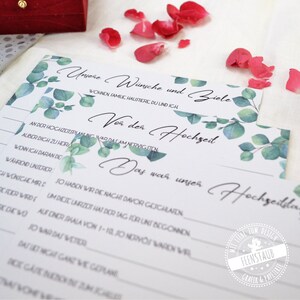 May include: A printable wedding game with a eucalyptus design. The game asks questions about the couple's wishes and goals before and after the wedding. The text on the game reads "Our wishes and goals" and "Before the wedding" and "What was our wedding like?"