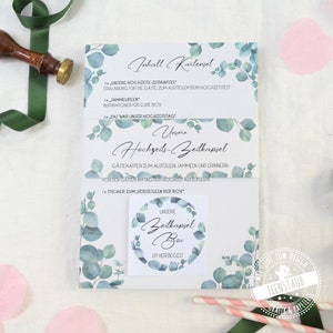 May include: A set of cards with a eucalyptus leaf design. The cards are titled "Our Wedding Time Capsule" and include instructions for guests to fill out cards with memories and wishes for the couple. The cards are packaged in a white box with a sticker that says "Our Time Capsule Box".