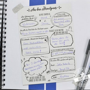 May include: A white card with black text and drawings. The card is a wedding guest book with prompts for the guests to write about the couple. The text includes "An das Brautpaar", "Vertrauen", "Der sch&ouml;nste Moment der Hochzeit war", "Euer Hochzeitstanz", "und nat&uuml;rlich DER KUSS!" and "Danke, dass ihr immer f&uuml;r mich da seit!"