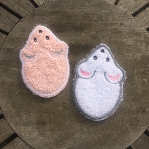 May include: Two plush, embroidered mouse-shaped hand towels. One is pink and the other is white.