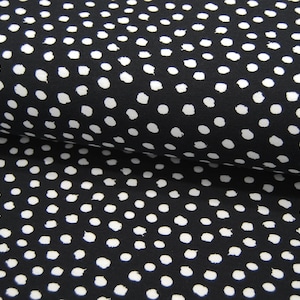 Könnte beinhalten: Schwarzer Stoff mit weißem Polka-Dot-Muster. Die Punkte sind leicht unregelmäßig geformt, was dem Stoff einen handgemalten Look verleiht.