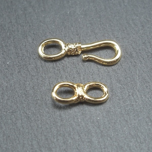 May include: Two gold-toned metal clasps for jewellery making. One clasp is a lobster claw style and the other is a figure eight style.