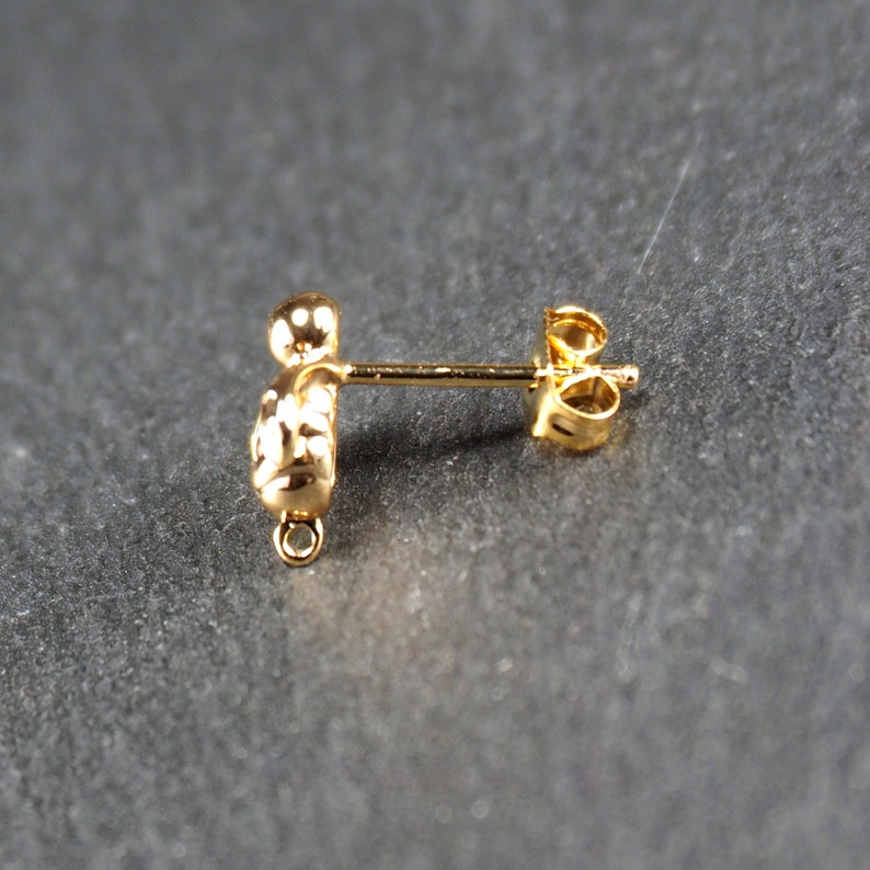 May include: Gold earring finding with a textured ball and a loop for attaching a dangle charm.