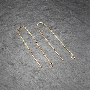 May include: Three gold chain earring extenders with jump rings. The extenders are different lengths.
