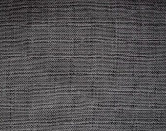 May include: Close-up of a dark grey woven fabric with a subtle texture. The fabric has a smooth, even weave and a slightly rough feel.