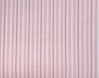 May include: Close-up of a fabric with vertical stripes. The stripes alternate between a soft pink and white, creating a classic striped pattern. The fabric appears to be woven, with a slightly textured surface.