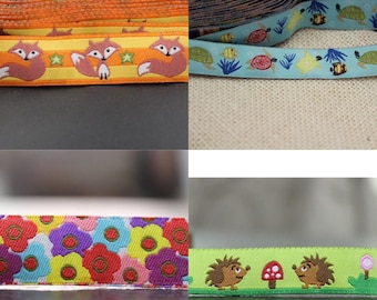 May include: Four different types of colorful ribbon trim with various animal and floral designs. The first ribbon features orange foxes on a yellow background with white stars. The second ribbon has a blue background with turtles, fish, and bees. The third ribbon has a multi-colored floral pattern. The fourth ribbon has a green background with two brown hedgehogs and a red mushroom.