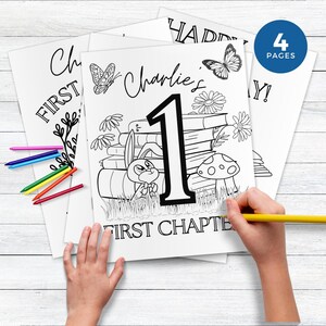 May include: A black and white colouring page featuring a bunny rabbit sitting on a stack of books with the number one and the text "Charlie's First Chapter".