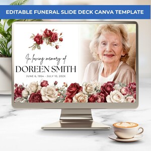 May include: A computer monitor displays an editable funeral slide deck template featuring a white background with red and cream rose illustrations. The text reads In loving memory of DOREEN SMITH JUNE 6, 1954 - JULY 10, 202X next to a portrait photo.