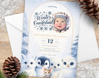 May include: A winter-themed birthday invitation with the text "Winter Onederland" and a photo of a baby. The invitation features illustrations of arctic animals, including a fox, penguin, bear, owl, and mouse. The date is set for Saturday, July 12th.