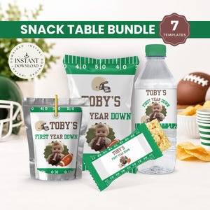 May include: A football-themed snack table bundle featuring seven templates for party supplies. Items include a silver pouch, a white chip bag, a water bottle with a green cap, and a candy bar wrapper, all personalized with the text Toby's First Year Down and a photo of a baby holding a football.