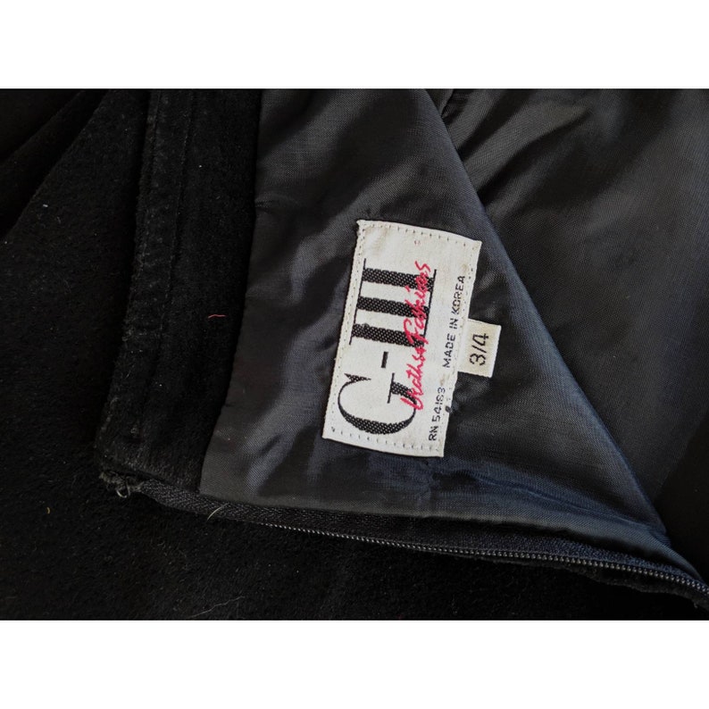 May include: A black velvet skirt with a label that reads "C-III  Classic Fashions  RN 54653  Made in Korea  3/4"