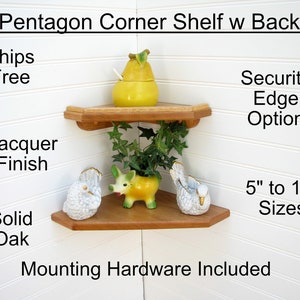 May include: A wooden pentagon corner shelf with a back, made of solid oak with a lacquer finish. The shelf is 5 to 16 inches in size and includes mounting hardware. It features a security edge option. The shelf is shown with decorative items.