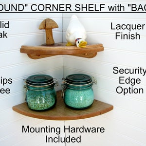 May include: A wooden corner shelf with rounded edges. The shelf is made of solid oak and has a lacquer finish. It comes with mounting hardware included. The shelf is shown with two glass jars and a decorative duck and mushroom.