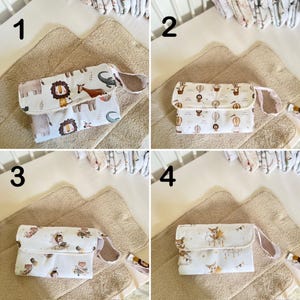 May include: Four different changing pad covers with various designs. The covers are white with different colored patterns. The patterns include animals, hot air balloons, and stars. The covers are all folded and laid out on a beige changing pad.